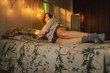 © Eloisa Ramos/Stocksy - Comfortable teen girl on the bed