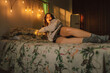 © Eloisa Ramos/Stocksy - Surprised teen girl on the bed