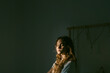 © Eloisa Ramos/Stocksy - Pretty teen girl relaxing sitting on her bed