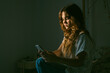 © Eloisa Ramos/Stocksy - Teen girl using her phone at night