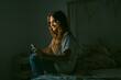 © Eloisa Ramos/Stocksy - Teen girl texting at bedroom
