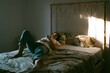 © Eloisa Ramos/Stocksy - Teen girl lying on the bed