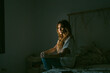 © Eloisa Ramos/Stocksy - Sleepless teen girl sitting on her bed