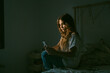 © Eloisa Ramos/Stocksy - Teen girl using her phone at bedroom