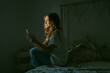© Eloisa Ramos/Stocksy - Teen girl using her smartphone at bedroom