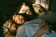 © Eloisa Ramos/Stocksy - Asleep teen woman smiling