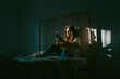 © Eloisa Ramos/Stocksy - Adolescent woman using her phone at bedroom
