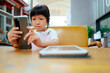 © Pansfun Images/Stocksy - little girl uses a cell phone