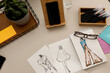 © Valentina Barreto/Stocksy - Clothing designs models on desk