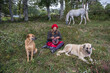 © Hakan & Sophie/Stocksy - woman knitting with her domestic animals close by
