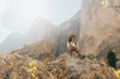© Kike Arnaiz/Stocksy - Young woman surrounded by mountains.