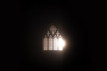 A Church Window Glowing At Night