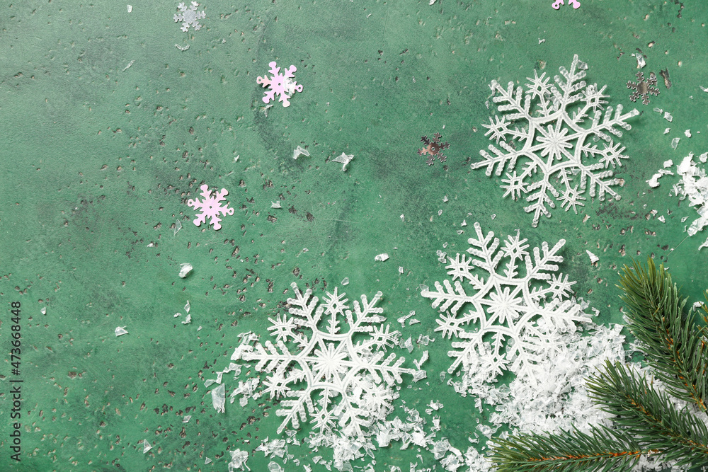 Beautiful snowflakes and fir branches on green background