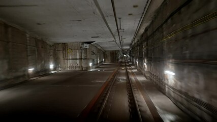 Wall Mural - View of subway tunnel from moving underground carriage. Slow motion of riding metro train in metropolitan city. Footage of modern public mode of transport in London