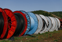 Large Colourful Cable Reels On The Grass

