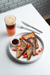 Honey and cinnamon french toasts with layered iced coffee on white table in a restaurant, top view