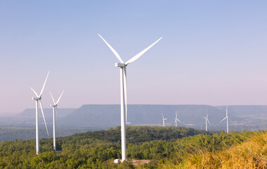  Many wind turbines in rows located with beautiful landscape on the hill with blue sky are operating to generate electric power which is the alternative energy resource for sustainable power supply.