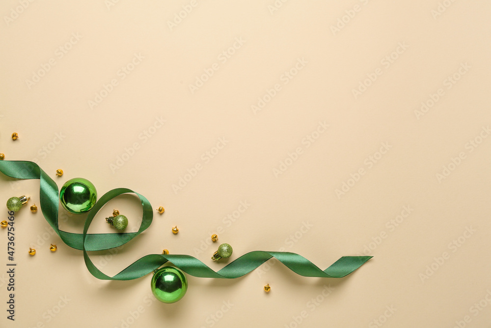 Composition with ribbon and Christmas decorations on color background
