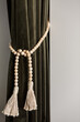 © Jodie Johnson Photography/Stocksy - Velvet curtain with tassel