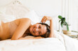 © Nuria Seguí/Stocksy - Young Woman Relaxing In Bed
