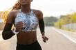 © BONNINSTUDIO/Stocksy - Fit black woman running on road