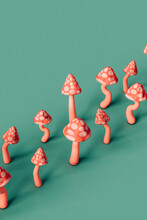 Pink Mushrooms Arranged In Row On Green Background