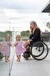 © Santi Nuñez/Stocksy - Mother in wheelchair enjoying with her daughter
