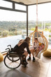 © Santi Nuñez/Stocksy - Mother in wheelchair playing with her daughter