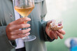 Anonymous Adult Holding Wine And Finger Food