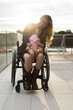 © Santi Nuñez/Stocksy - Mother in wheelchair enjoying with her daughter