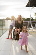 © Santi Nuñez/Stocksy - Portrait of mother in wheelchair with her daughters