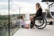 © Santi Nuñez/Stocksy - Mother in wheelchair enjoying with her daughter