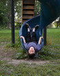 © Angela Waye/Stocksy - Bored Boy on Slide