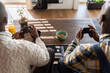 © Hernandez & Sorokina/Stocksy - Men Holding Gaming Consoles From Above