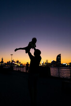 Silhouette Of Dad Holding Up Baby
