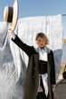 © Julie Meme/Stocksy - A  blonde girl  with the hat in her hand in the outdoor