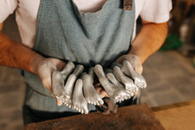 Crop artisan working with metallic foot pieces