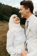 © Melika Tursic/Stocksy - Happy couple standing and laughing in the mountains