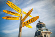 © Amos Chapple/Stocksy - A signpost in front of the Cape Reinga Lighthouse.