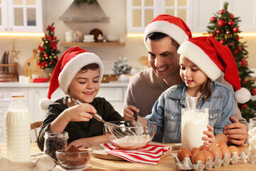 Wall Mural - Happy father and his children making dough for delicious Christmas cookies at home