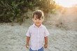 © Kelsey Smith/Stocksy - Toddler smiling at the beach