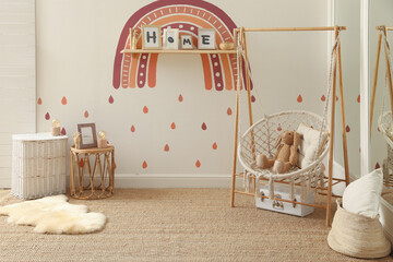 Child's room interior with rainbow painting on wall