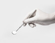 © OPEN.TESM - Dental mirror tool in dentist hand on white backgroud