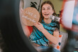 © Westend61 - Girl showing like and subscribe sign while vlogging at home