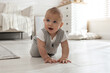 © New Africa - Cute baby crawling on floor at home