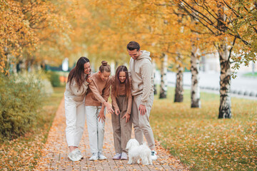 Wall Mural - Portrait of happy family of four in autumn day