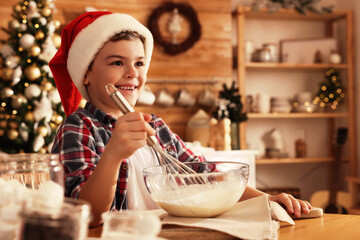 Poster - Cute little boy in Santa hat making dough for Christmas cookies at home