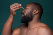 © Inesio Samuel/Stocksy - African man with skin problems applying oil
