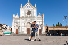 Female Tourist Pointing While Standing By Man At Piazza Di Santa Croce, Florence, Italy