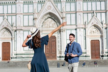 Female Tourist Gesturing While Standing With Man At Piazza Di Santa Croce, Florence, Italy